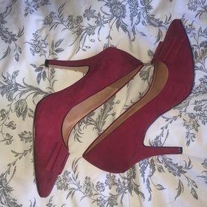 Red pointed toe heels with front subtle bow